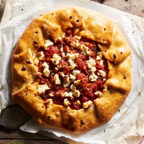 Overhead view of rustic tomato goat cheese galette made with Muir Glen Whole Tomatoes topped with fresh goat cheese.