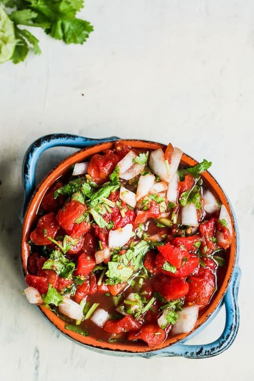 Bowl of pico de gallo salsa topped with cilantro