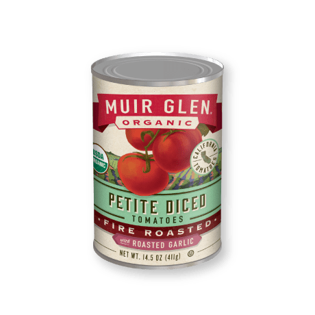 Muir Glen Organic Fire Roasted Petite Diced Tomatoes with Roasted Garlic, front of product.